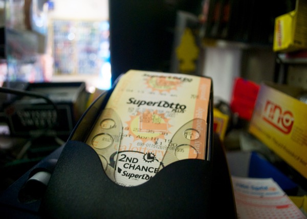 A machine at King's Liquor prints out SuperLotto Plus tickets. Credit: Leo Castaneda/inewsource